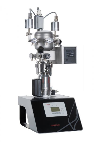 A state-of-the-art laboratory equipment with multiple valves and sensors, featuring a central cylindrical component atop a black and silver base with a digital display. The device is labeled "Calibration system CS3 Standard" by Leybold North America and includes a small screen for data display.