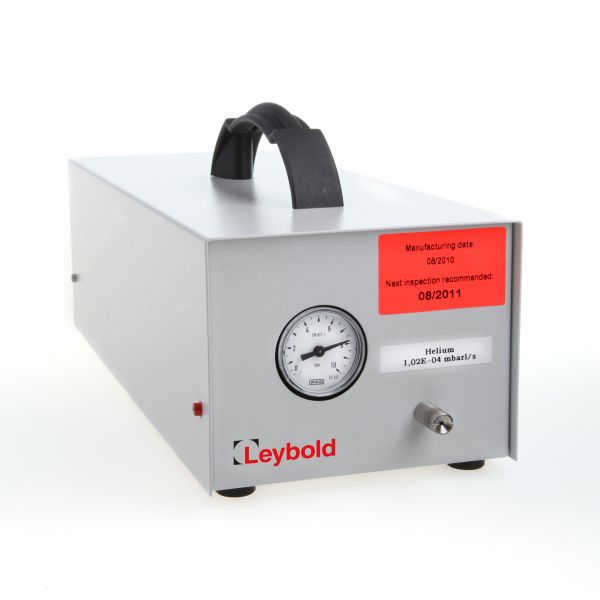 The Leybold North America S-TL 4 Sniffer Test Leak features a handle, pressure gauge, nozzle, and helium gas reservoir. The silver unit displays the logo and helium readings; a red label indicates inspection dates for precise industrial leak detection.