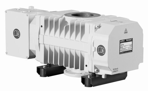 The RUVAC WH 700 vacuum pump by Leybold North America is predominantly grey with a rectangular body and fins for heat dissipation. It features a label displaying model details and safety symbols, along with protruding parts and connectors for various attachments on both sides.