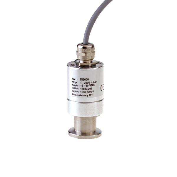 A cylindrical pressure sensor with a stainless steel body is connected to a grey cable at the top. The label on the sensor includes model and technical specifications such as input voltage and pressure range. The Absolute Pressure Sensor DI 2000, DN16KF by Leybold North America appears to be made in Germany.