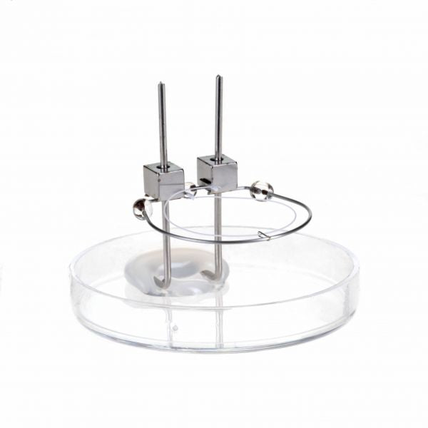 A Replacement Cathode for IE 511 / IE 514 by Leybold North America, positioned on a transparent circular stand. The design is sleek and modern, showcasing a minimalistic aesthetic that excels in functionality. The metallic finish complements the clear stand, providing an efficient contemporary appearance.