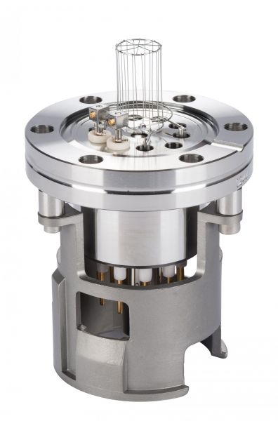 The IONIVAC-Sensor IE 514 by Leybold North America is a metallic cylindrical scientific apparatus with several bolts around its circular top and a vertical grid-like structure protruding from the center. The base features multiple connectors and ports, indicating it is a sophisticated piece of laboratory equipment.