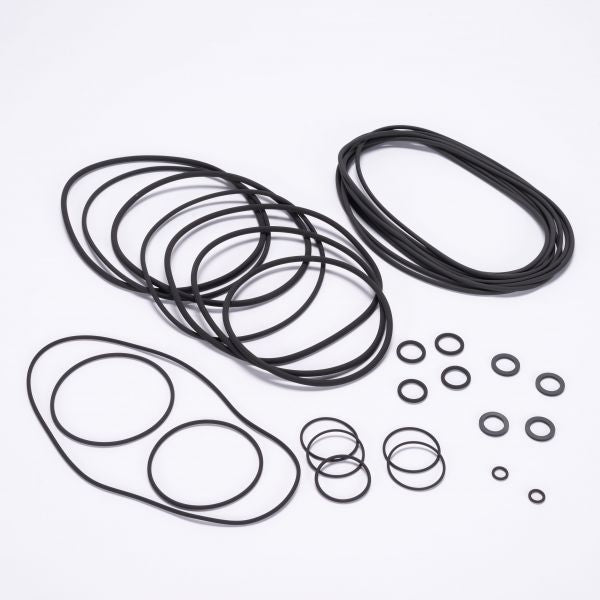 A collection of black rubber O-rings from the Seal Kit RUVAC WS/WSU 2001 - BR2 by Leybold North America, displayed on a white background. The O-rings are grouped by size, ranging from small to large, and are either circular or elliptical in shape.