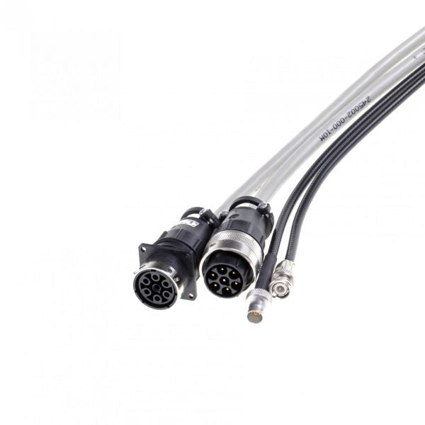 Close-up of Leybold North America's Extension for Connecting Cable IM 540 - IE 414 / IE 514 (10m) with large multi-pin connectors in black and metallic finishes, ideal for industrial use. Includes labeled coaxial connectors against a plain white background, perfect for any electrical setup.