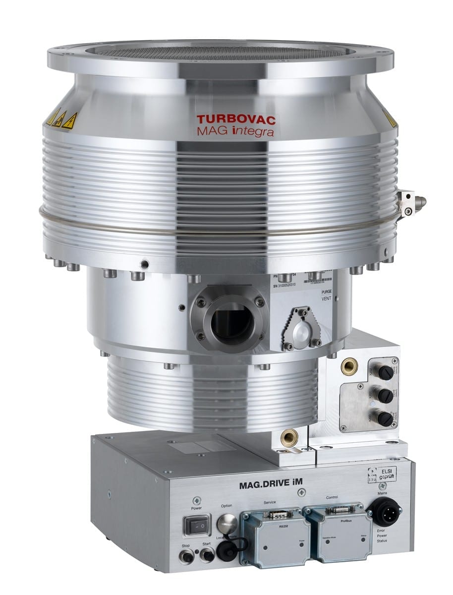 Image of a high-tech piece of laboratory equipment, specifically the Leybold North America Shop TURBOVAC MAG W 1600 iP. The device is metallic with a cylindrical upper section and various ports, switches, and connectors on the base unit labeled MAG.DRIVE IM. The equipment appears highly specialized.