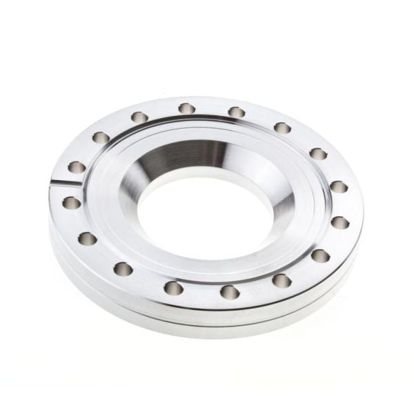 A Leybold North America Reducing Flanges DN 100/63 CF, featuring a metallic circular design with a central hole and evenly spaced outer holes, is commonly used in pipe systems. Shown on a white background.