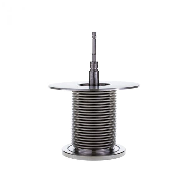 On a white background, the Spare Inner Valve Assembly for Right Angle Valve DN 100 ISO-K - EP by Leybold North America is accompanied by a metal coil spring with a central rod. The spring, which is tightly wound and vertically oriented with a disc-like top and base, demonstrates its precision for optimal flow control applications.
