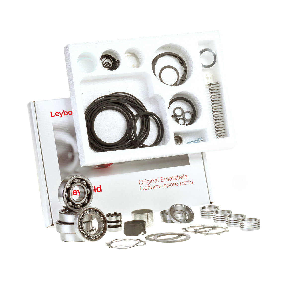 An open packaging box with multiple compartments containing assorted mechanical components including springs, O-rings, seals, and bearings. The box has "Leybold Major Maintenance Kit WSU 501 Genuine spare parts" written on it.