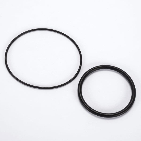 On a white background, two black rubber O-rings from the Leybold North America Seal Kit for Right Angle Valve DN 63 ISO-K are displayed side by side. One ring is larger and thinner, while the other is smaller and thicker.