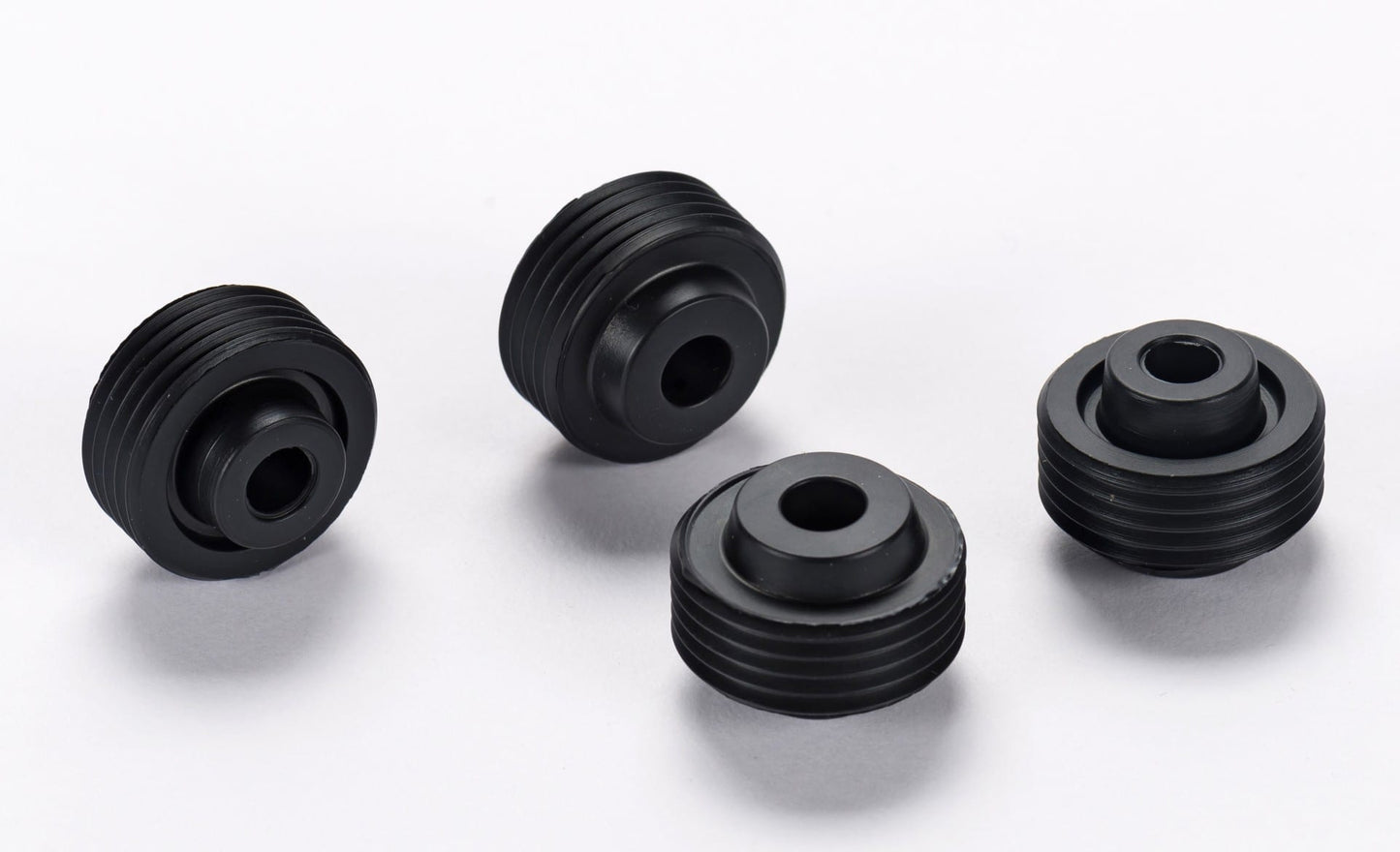 A group of black metal objects: FEET, Trivac 1.6 - 65B 4 pieces by Leybold.