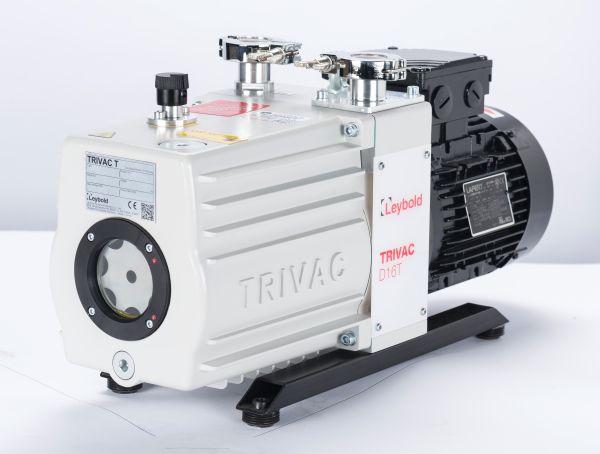 A Leybold TRIVAC D 16 T vacuum pump with a white and black casing, featuring multiple valves and gauges on top. The pump is positioned on a flat surface with "TRIVAC" and "Leybold" labels visible on its casing.