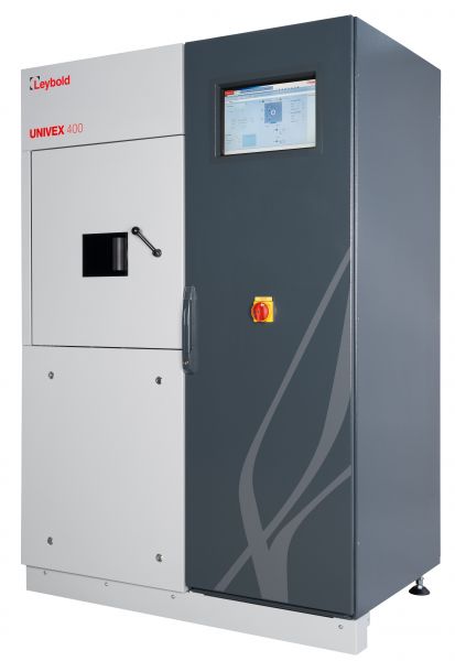 A Leybold North America HV-experimentation system UNIVEX 400 vacuum coating system. The machine has a rectangular shape with a grey and white exterior. A small viewing window is on the left panel and a touchscreen interface at the top of the right panel. A yellow emergency stop button is below the touchscreen.