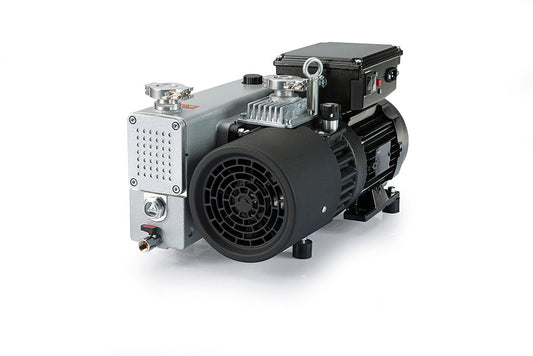 The NEO D25 by Leybold is a silver and black industrial vacuum pump with a rectangular design, reduced noise levels, a grid-patterned front panel, and a cylindrical black side fan. It rests on a white reflective surface that highlights its sleek presence.