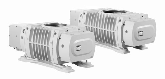 Two RUVAC WHU 7000 high-performance vacuum pumps from Leybold North America, displayed in a horizontal configuration. Both metallic units sport a sleek design with ribbed exteriors and visible nameplates, positioned side by side against a light background.