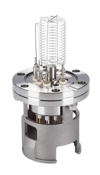 A close-up view of the Leybold North America IONIVAC-Sensor IE 414, a metallic scientific instrument featuring various connected components and wires, including a coiled wire structure on top. The sensor has a cylindrical base and multiple connection points, showcasing its complex and technical design.