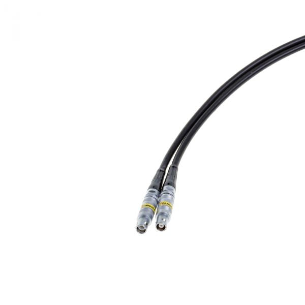 A close-up shows two black coaxial cables from Leybold North America's Connecting Cable for PR-sensors (10m), featuring metallic connectors on a white background, extending diagonally from the bottom left to top right corner.