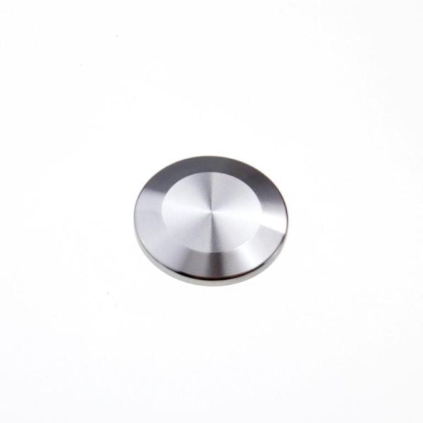 A small, round, metallic silver disc resembling a blank flange from Leybold North America is centered on a plain white background. The shiny stainless steel Blank Flanges DN 10 ISO-KF capture light, creating subtle highlights and a gradient effect, evoking components in vacuum applications.