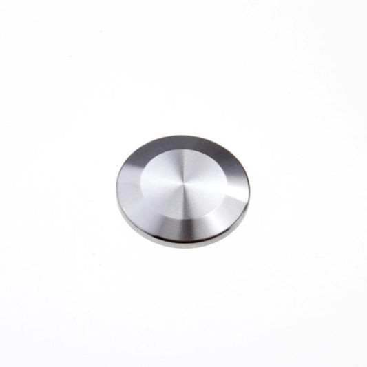 A metallic, circular Blank Flange ISO-KF with a smooth, reflective surface is centered against a plain white background. The flange's surface reflects light, giving it a shiny appearance. It appears to be made of stainless steel or similar material and is manufactured by Leybold North America.