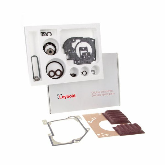 Image depicting an open box from Leybold North America containing various spare parts for machinery, including a Seal Kit TRIVAC S/D 16-25 B for an oil-sealed vacuum pump. Visible parts include gaskets, O-rings, and other components organized in a foam case. The exterior of the box, showcasing the Leybold North America brand, is visible behind the foam insert.