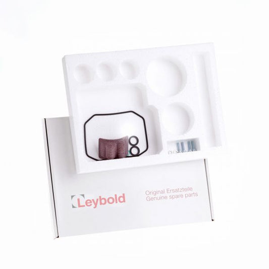 A Leybold North America packaging box partially open, revealing a white foam tray inside. The tray contains various small components: an O-ring, screws, and other spare parts. The Leybold North America logo and text "Maintenance kit TRIVAC D 2,5 E Genuine spare parts" are visible on the box.