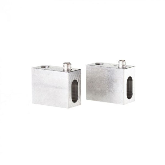 Two rectangular metal blocks with threaded holes and side cutouts are displayed on a white background. These components are identified as "Plug for UHV-Current feedthrough FE 16/1 / FEHC 16/1 / FEHC 40/2 - vacuum side" by Leybold North America, and they are designed for use in ultra-high vacuum environments in mechanical or industrial applications.