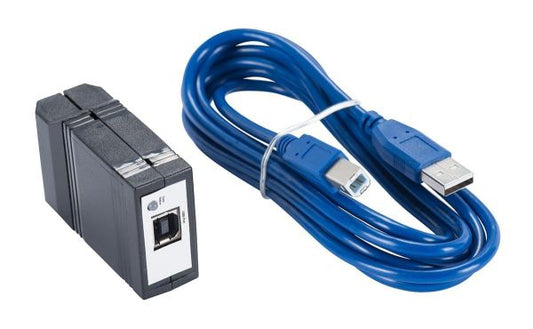 A black and white electronic device with a USB port, the Leybold North America Adapter USB / RS232, accompanied by a coiled blue USB cable featuring standard USB-A and USB-B connectors tightly bound with a white twist tie.