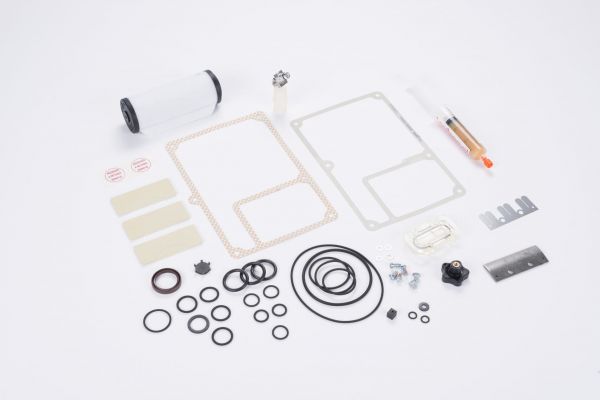 A variety of small mechanical parts, including the Leybold North America Complete Repair kit SOGEVAC SV 16 / SV 25 - BR2, are arranged neatly on a white surface.