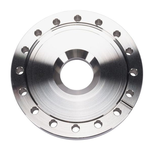 Close-up of a Leybold North America Reducing Flanges DN 100/40 CF, featuring a shiny metal finish, large central hole, and multiple smaller holes around the edge for optimal performance and corrosion resistance, viewed from above on white background.