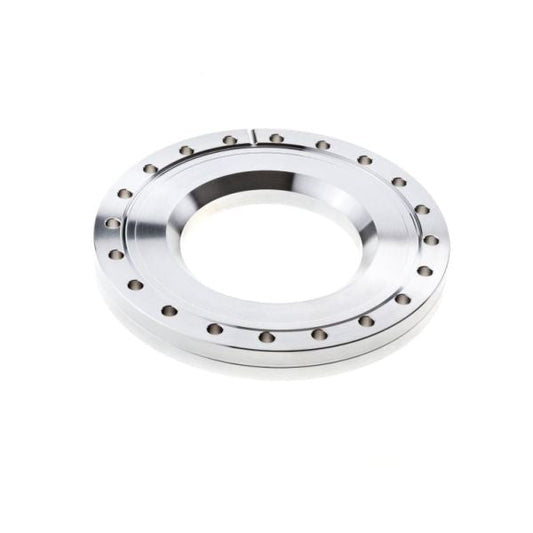 A close-up of a Reducing Flanges CF from Leybold North America. The circular metallic flange has a clean, polished finish with holes evenly spaced along its outer edge and a central opening. The plain white background highlights the precise engineering of this component.