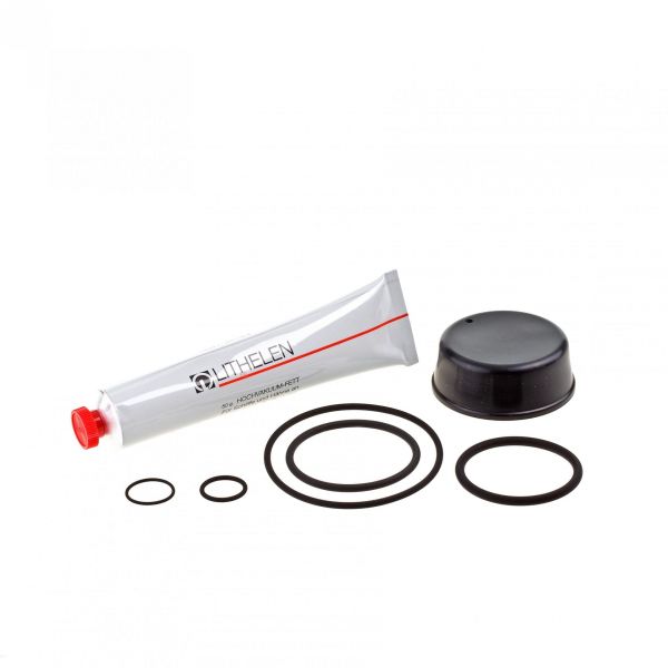 A Seal Kit for SECUVAC Valve DN 40 ISO-KF, comprising a tube of lubricant with a red cap, various black rubber O-rings, and a black cap, is displayed on a plain white background. These components from Leybold North America are crucial for maintaining your SECUVAC valve in vacuum applications.