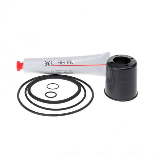 A Seal Kit for SECUVAC Valve DN 63 ISO-K branded "Leybold North America" placed next to a black cylindrical object, most likely a piston or cylinder, and five black rubber O-rings of various sizes arranged neatly on a white background.