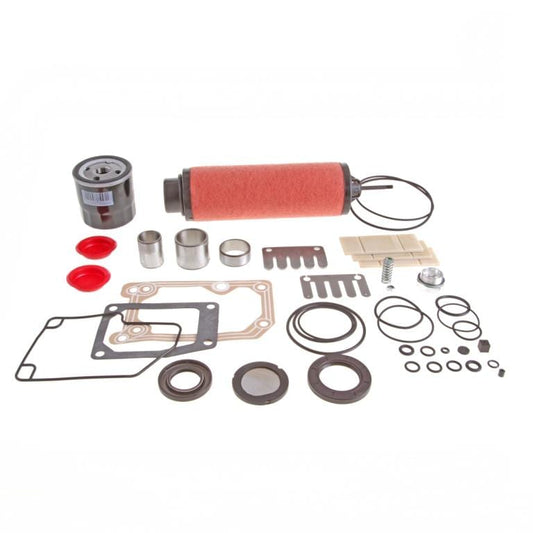 Image of a collection of mechanical parts including a red cylindrical filter, gaskets, O-rings, screws, bushings, and other components from the Leybold Repair Kit SV 65 B arranged neatly on a white background.