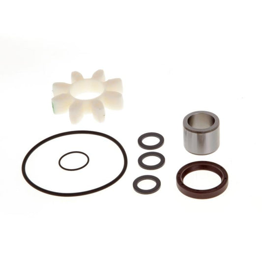 Displayed against a white background is the Leybold Radial Shaft Seal Exchange Kit TRIVAC S/D40/65B, which includes a set of mechanical parts such as a white sprocket, large and small rubber O-rings, three small circular rubber gaskets, a metal cylinder, and a brown cylindrical part.