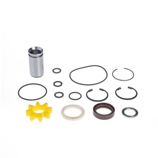 A Sleeve and Shaft Seal Kit RUVAC WA/WAU 251-501 by Leybold including various components: one metallic cylinder tube, multiple black O-rings and seals of different sizes, two circlips, a yellow plastic star-shaped piece, and brown and white seals. All items are arranged on a white background.