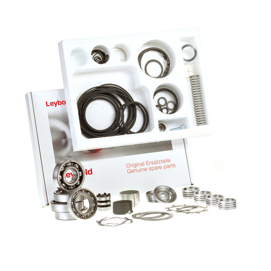 An open packaging box with multiple compartments containing assorted mechanical components including springs, O-rings, seals, and bearings. The box has "Leybold Major Maintenance Kit WSU 501 Genuine spare parts" written on it.